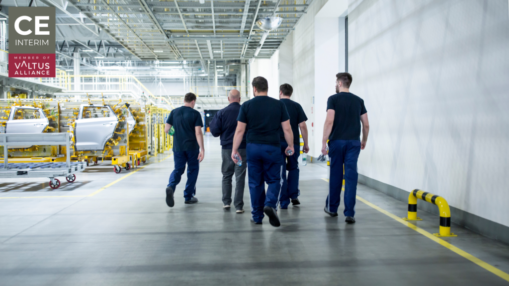 European manufacturing employees entering a factory before shift change
