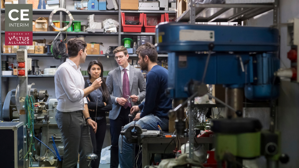 Plant management team reviewing production performance at a live manufacturing line