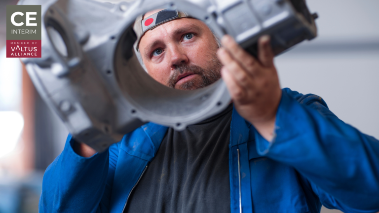 Technician overhauling industrial equipment inside a Gulf service workshop.