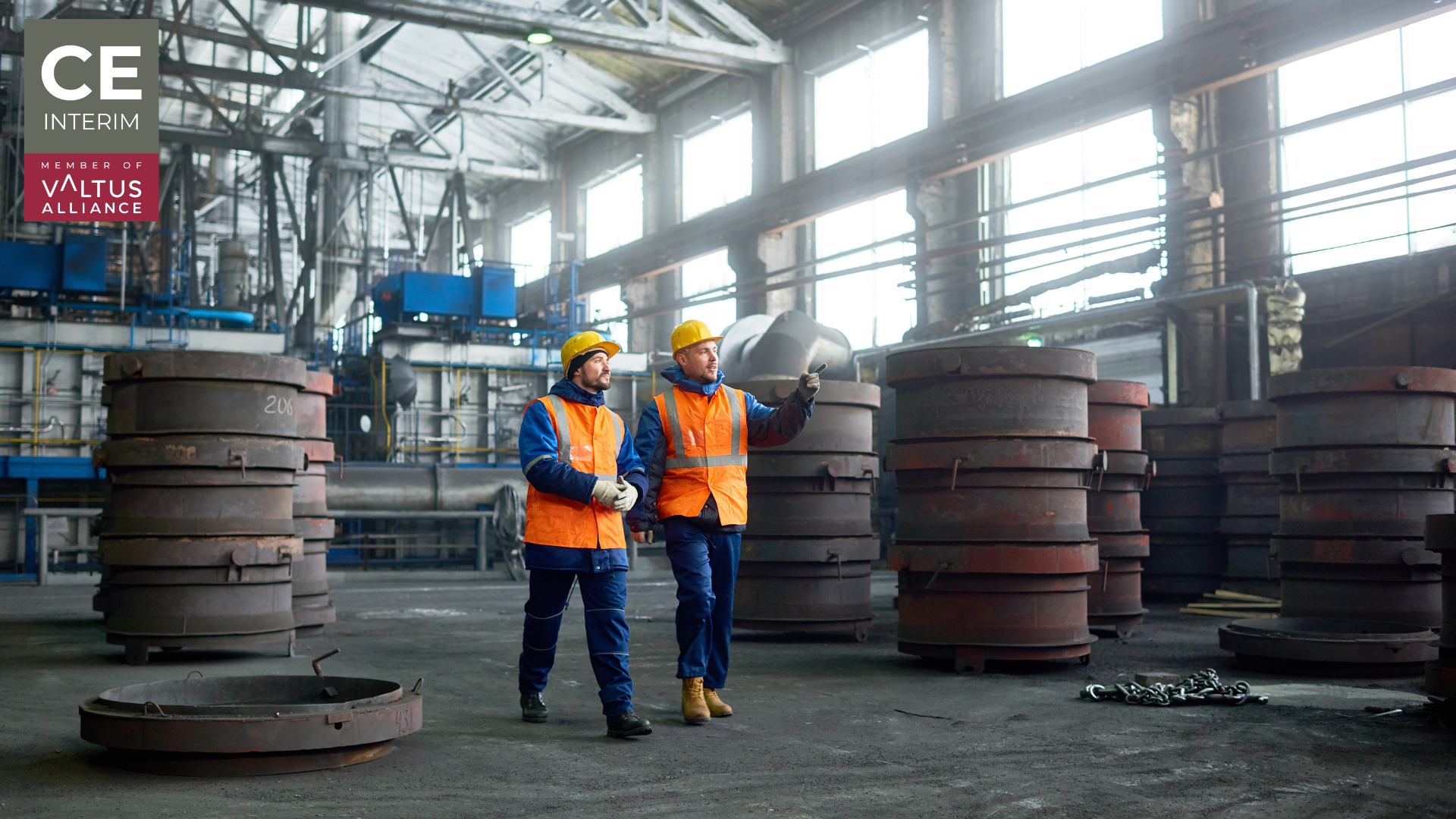 Plant engineer and local operator reviewing work instructions beside a running production line.