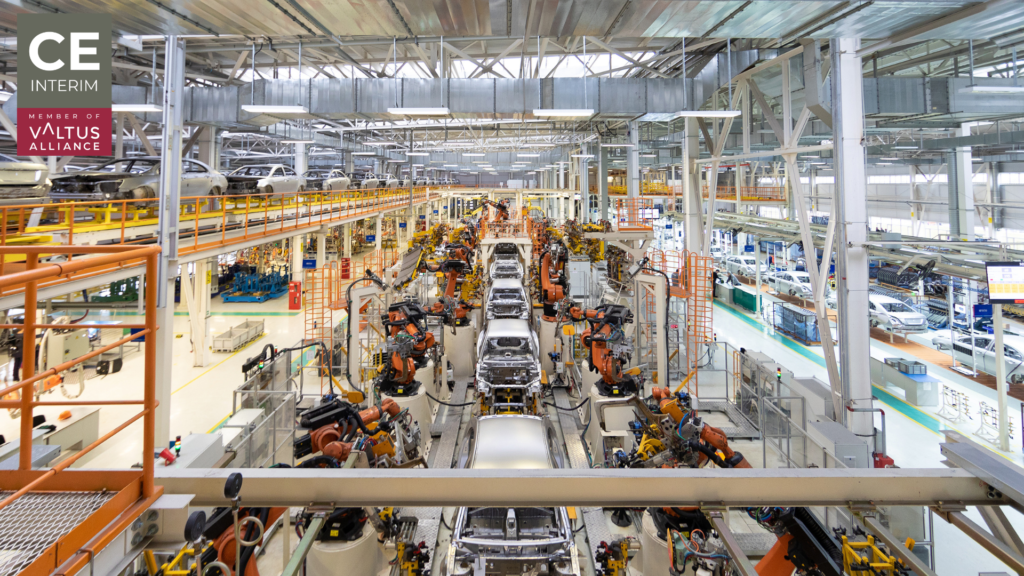 Multi-line automotive manufacturing assembly floor with multiple production stations and quality control checkpoints visible simultaneously.